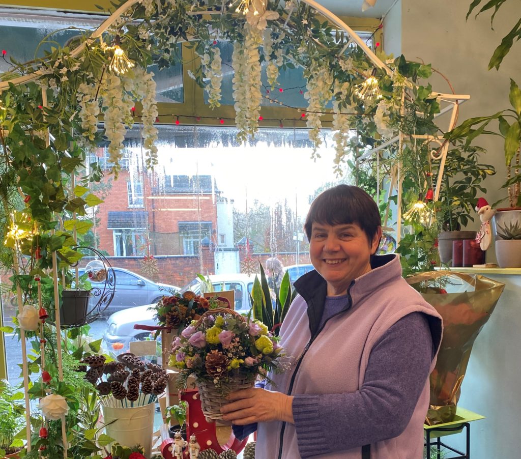 Izzy, owner of Make Their Day flowers stands proudly in her Charlton Kings florist in Cheltenham for a post about the importance of shopping locally.